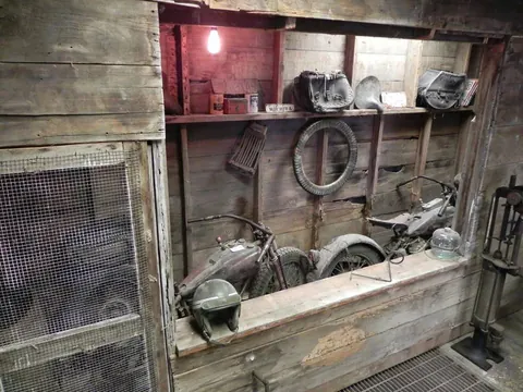 Antique engines and parts in a barn-wood display