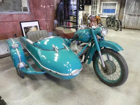 Turquoise 1967 Russian Izh motorcycle with finned sidecar